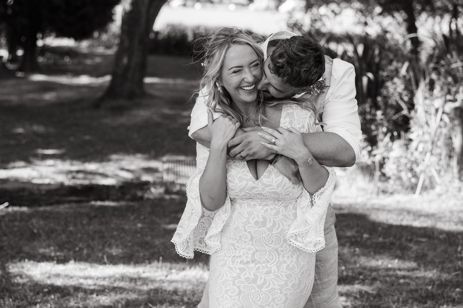 A tender moment shared between a couple on their wedding day captured in black and white photography.