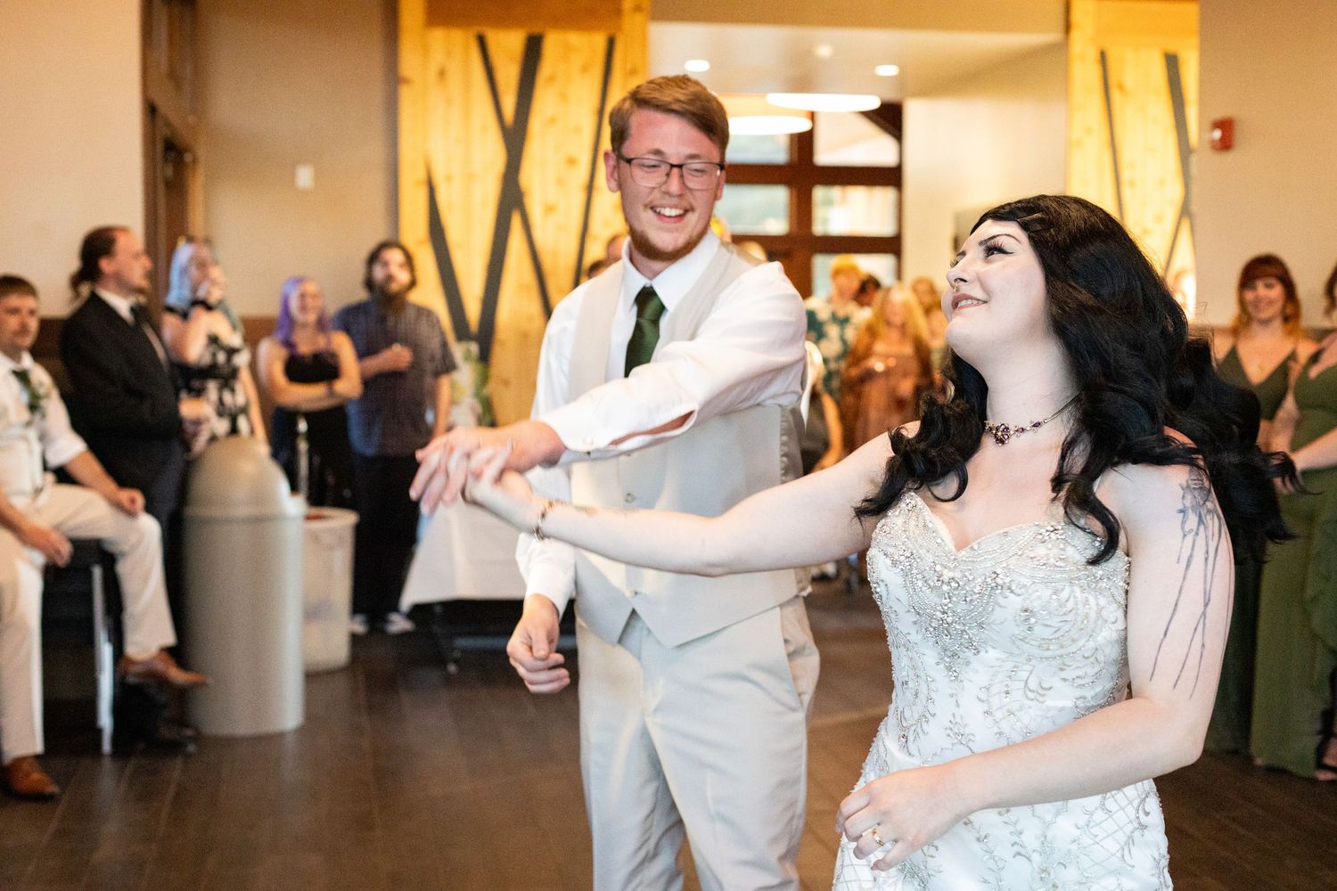 Wedding reception dance party with guests celebrating in an elegant indoor venue.