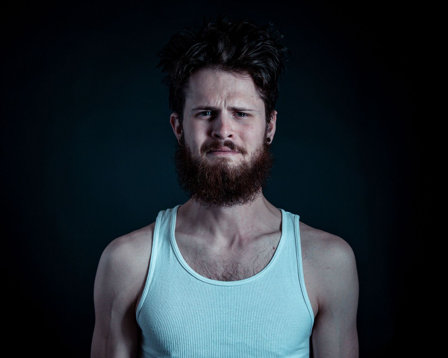 A series of portrait photographs showing a person in a light blue tank top against a dark background.