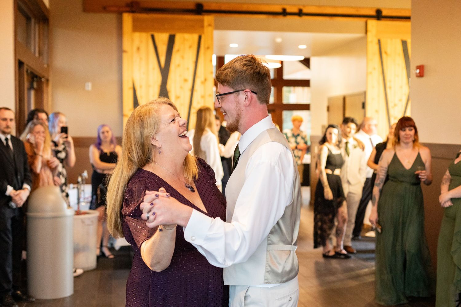 Couples dancing together at an elegant indoor wedding reception.