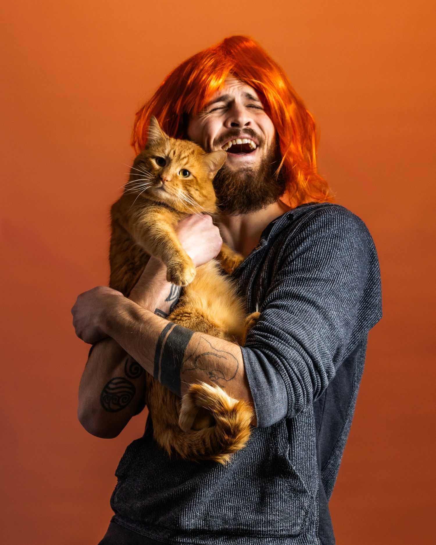 A series of playful moments between a person in a gray sweater and an orange cat against a warm orange background.