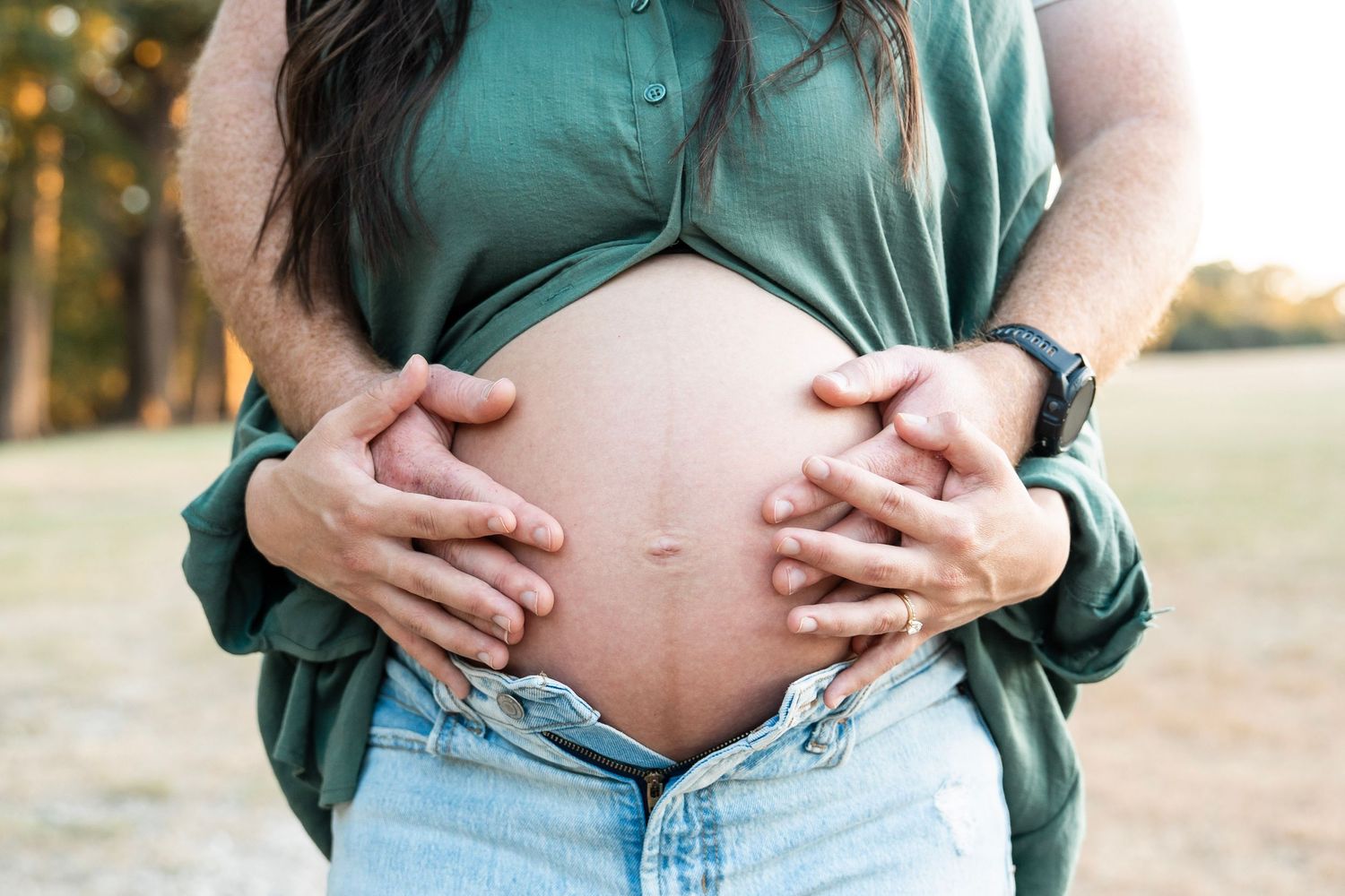 Maternity photo series showing close-up shots of pregnant belly in green shirt against warm outdoor lighting.