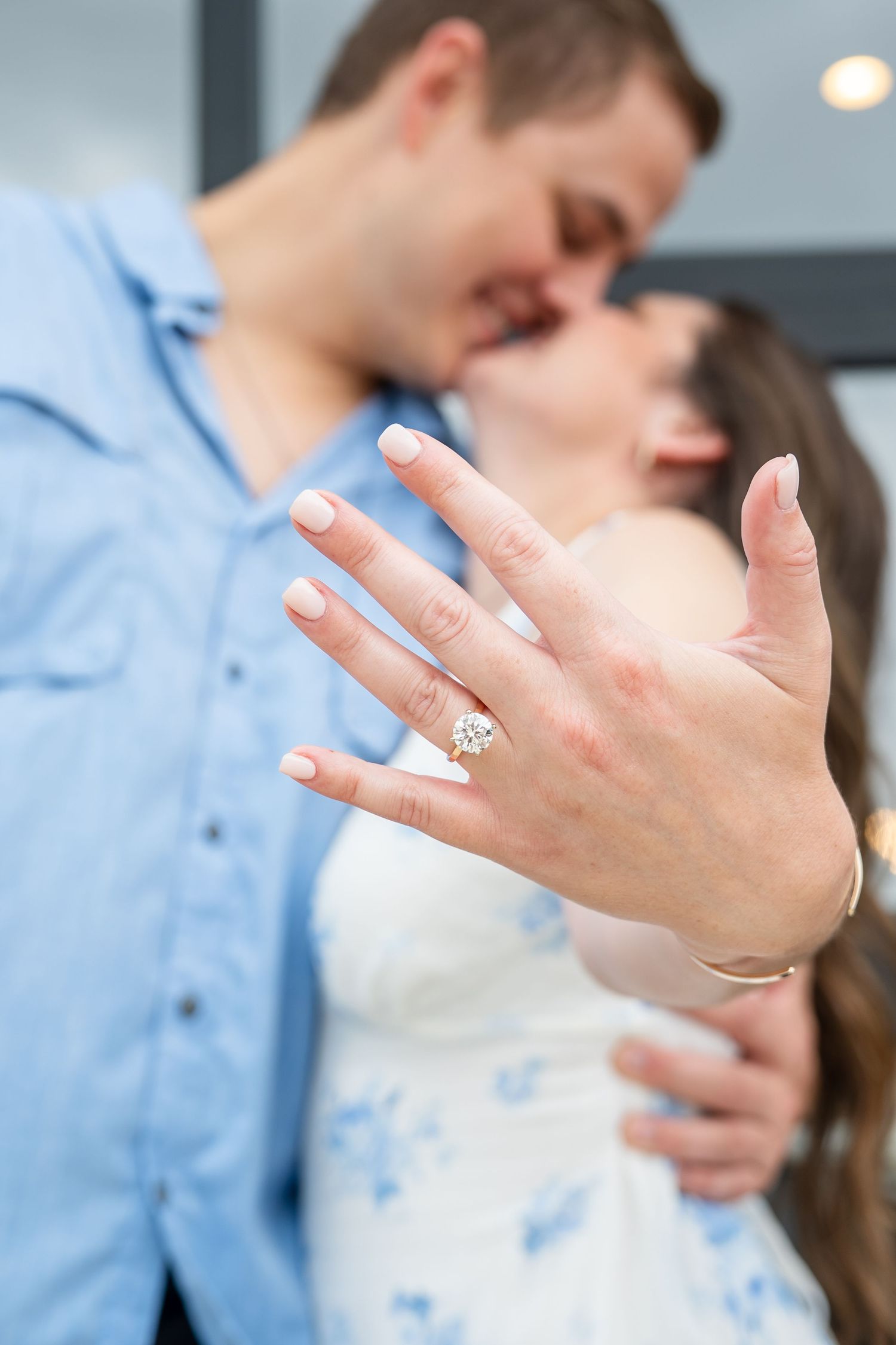 A close-up sequence showing hands wearing engagement rings in natural lighting.