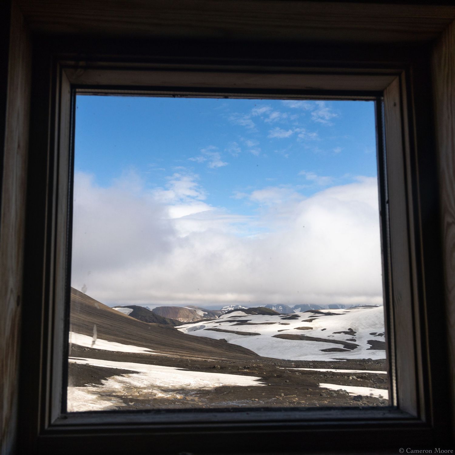 Framed fine art print displaying a snowy highland landscape beneath a bright blue sky. Iceland