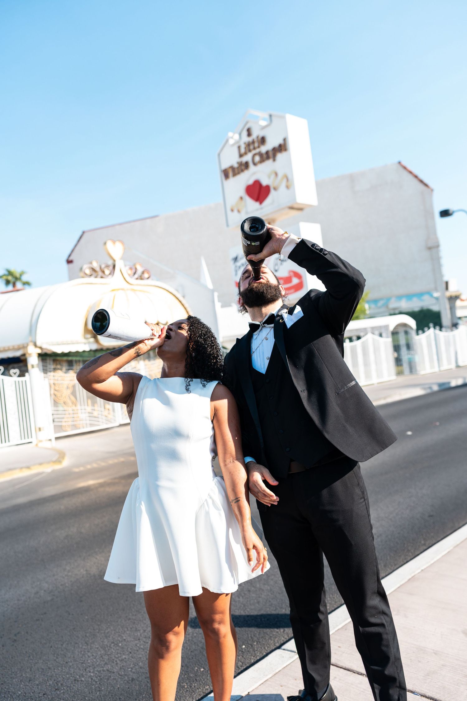 A couple drinking from bottles outside the Little White Chapel in Las Vegas.