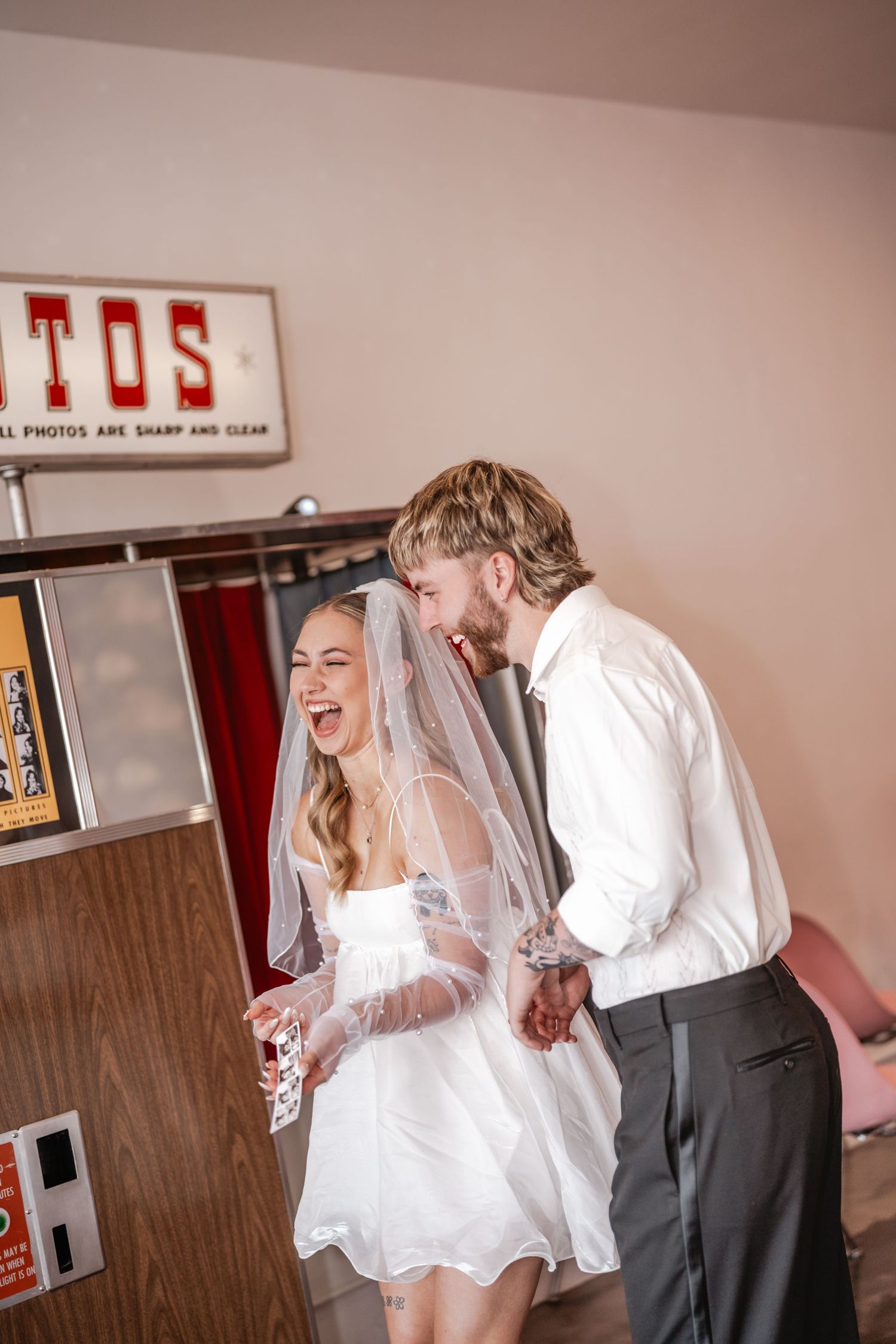 Candid moments of laughter shared in a casual indoor setting during wedding preparations.