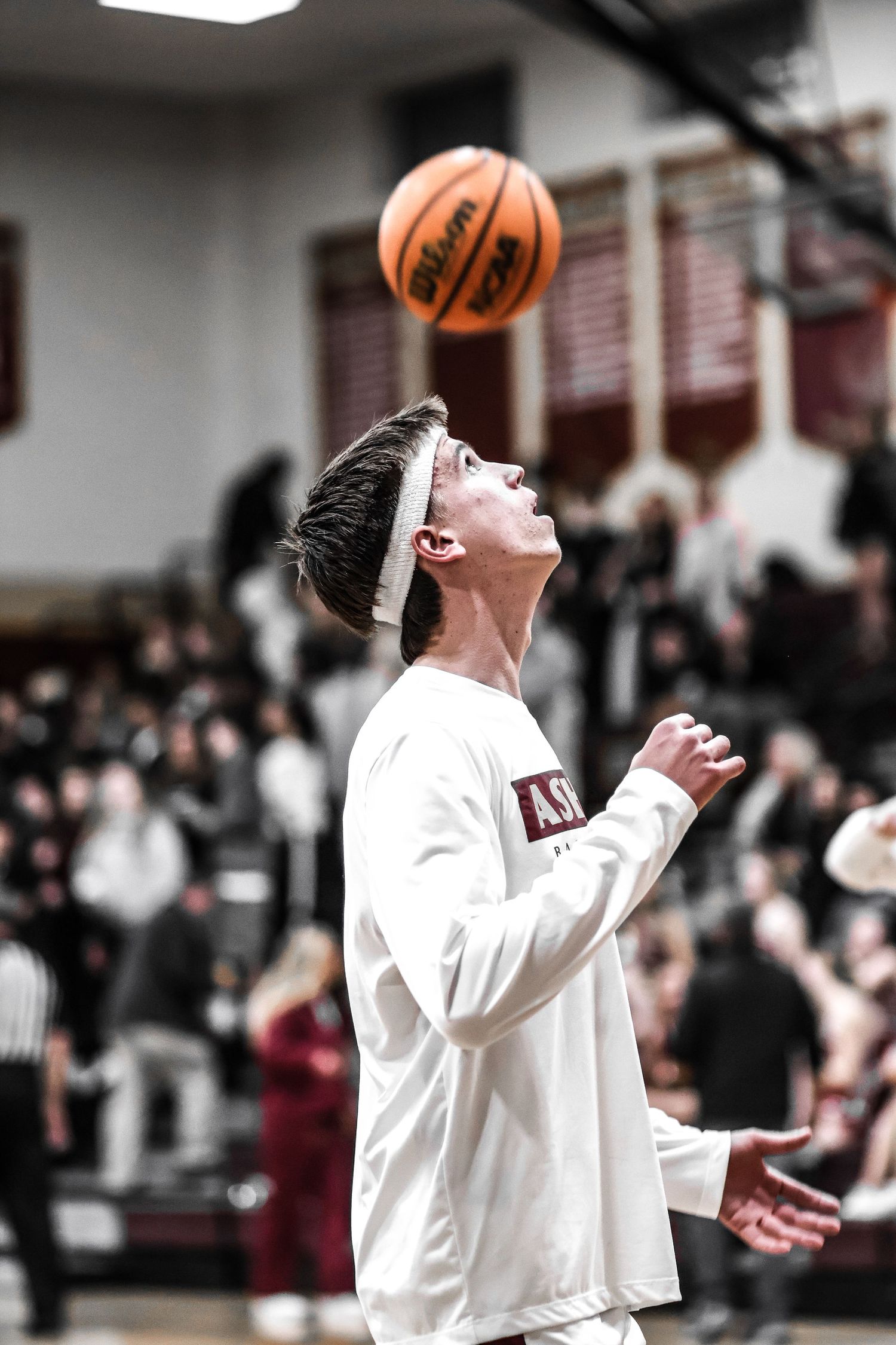 Basketball player in white uniform celebrates with enthusiasm during game.