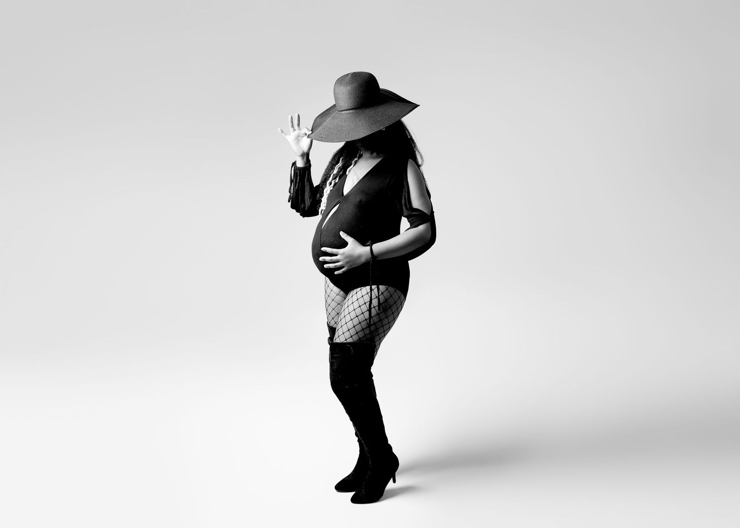 Black and white artistic maternity silhouettes against white background.