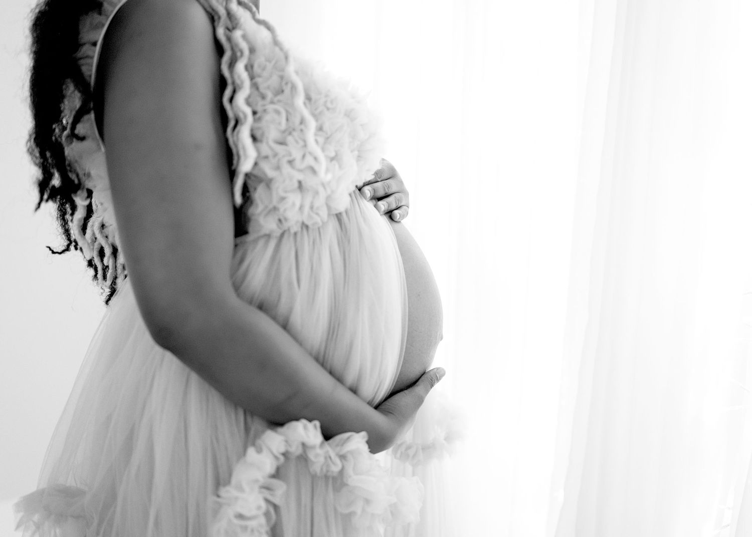Ethereal maternity portraits in flowing white lace gown.