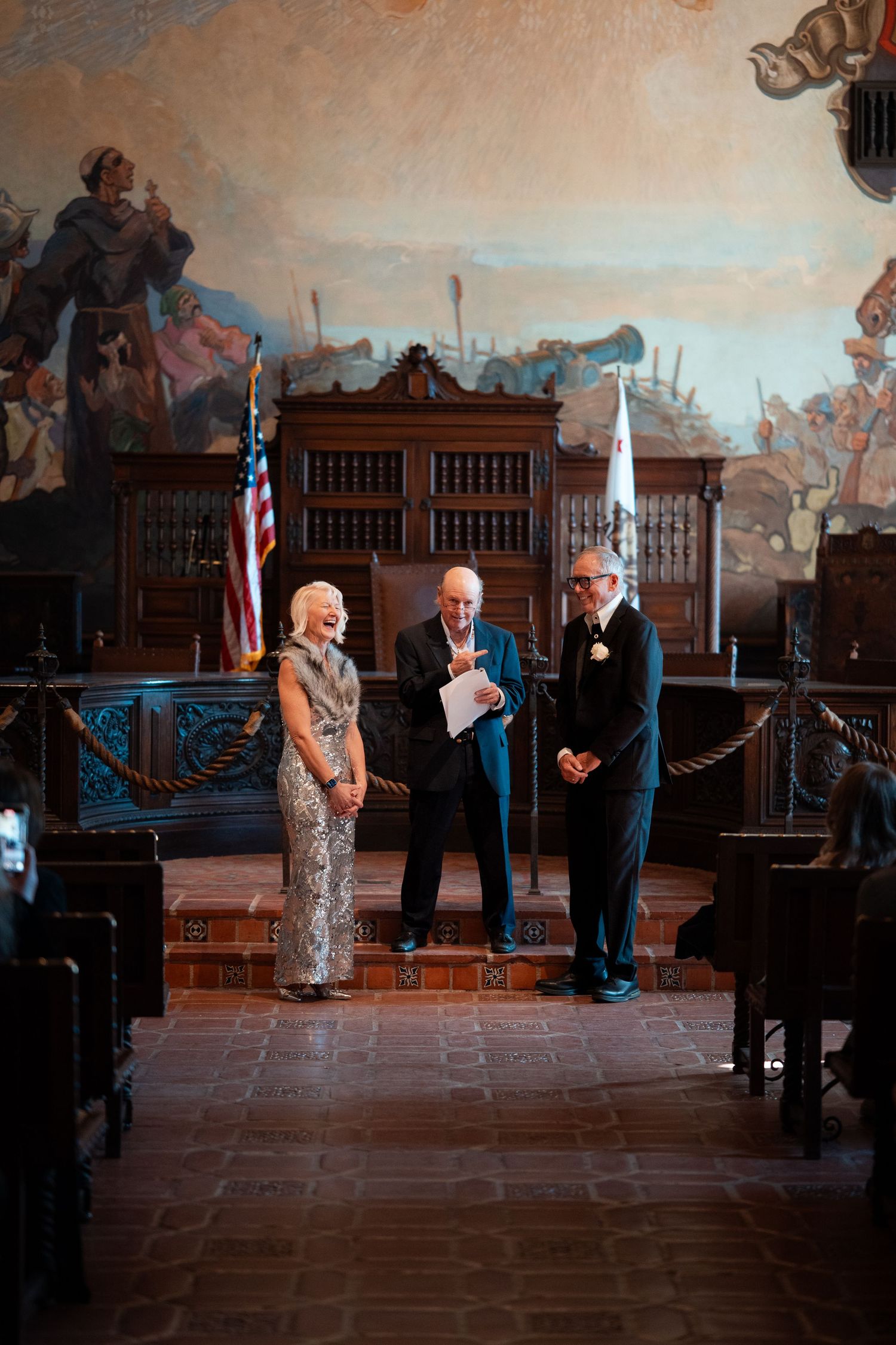 Natural editorial documentary Santa Barbara courthouse wedding moment of a couple standing before the officiant in the ornate ceremony hall.
