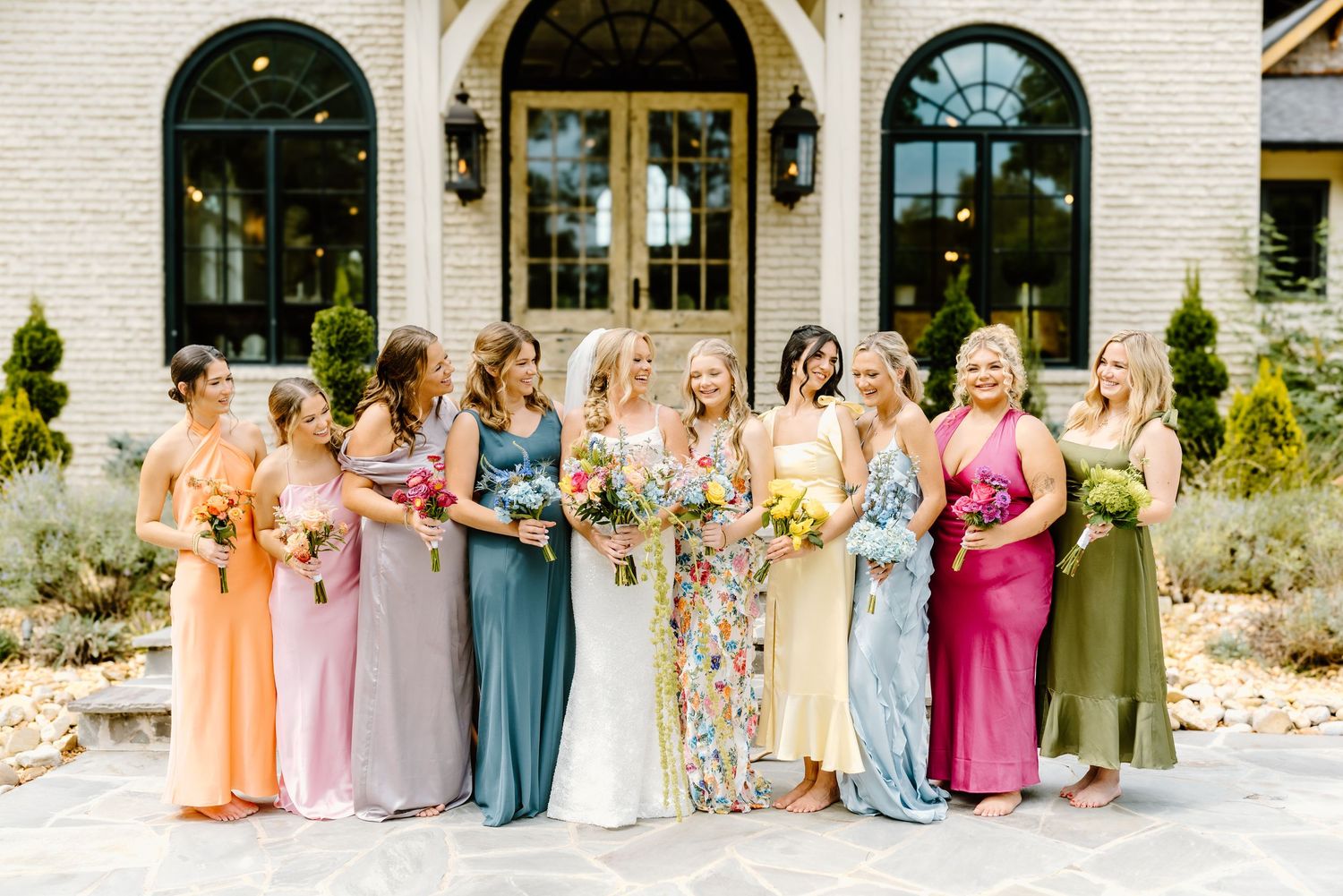 A panoramic collage of wedding party photos shows groups posing outdoors in pastel-colored attire.