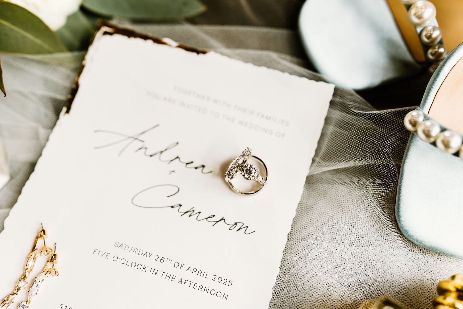 Wedding stationery and invitation details with elegant calligraphy on white paper.