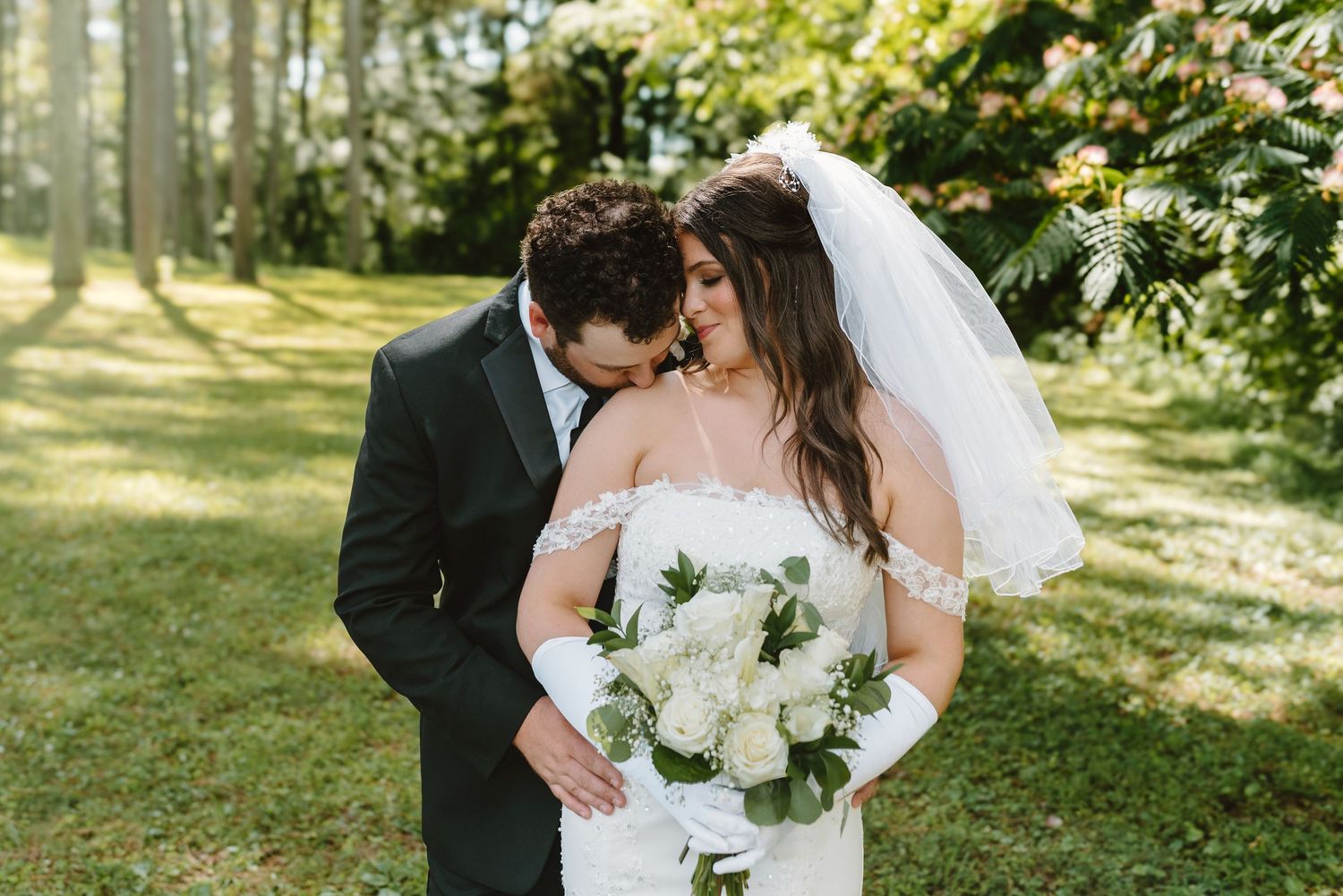 A romantic wedding photo series showing a couple embracing in a sunny garden setting.