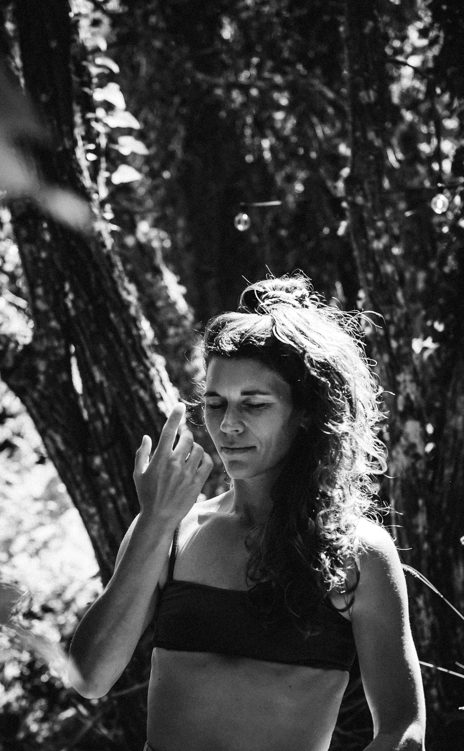 Black and white portraits in forest setting with sunlight filtering through trees.