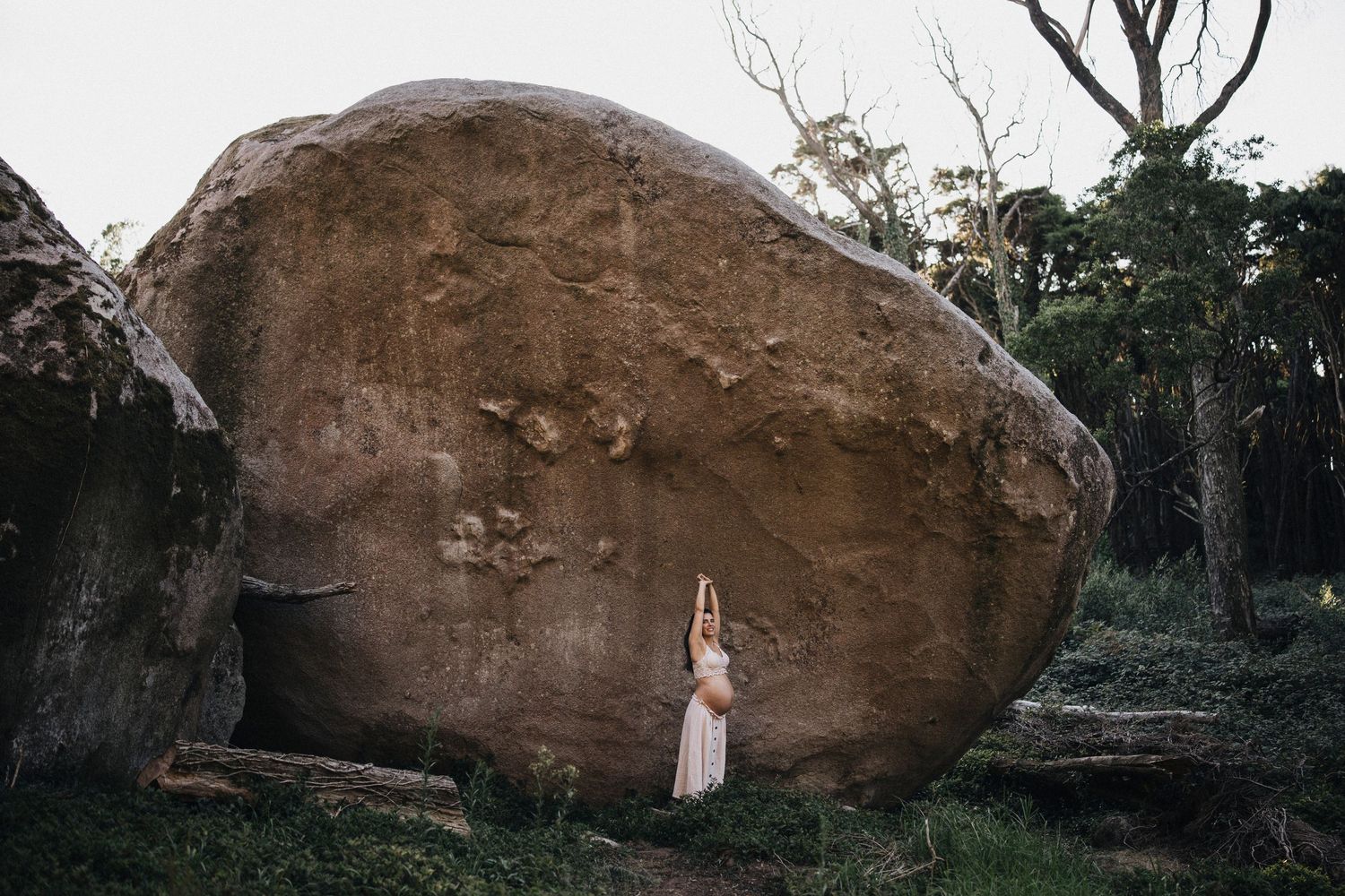 Panoramic view of a large boulder in a wooded setting during a photo session.