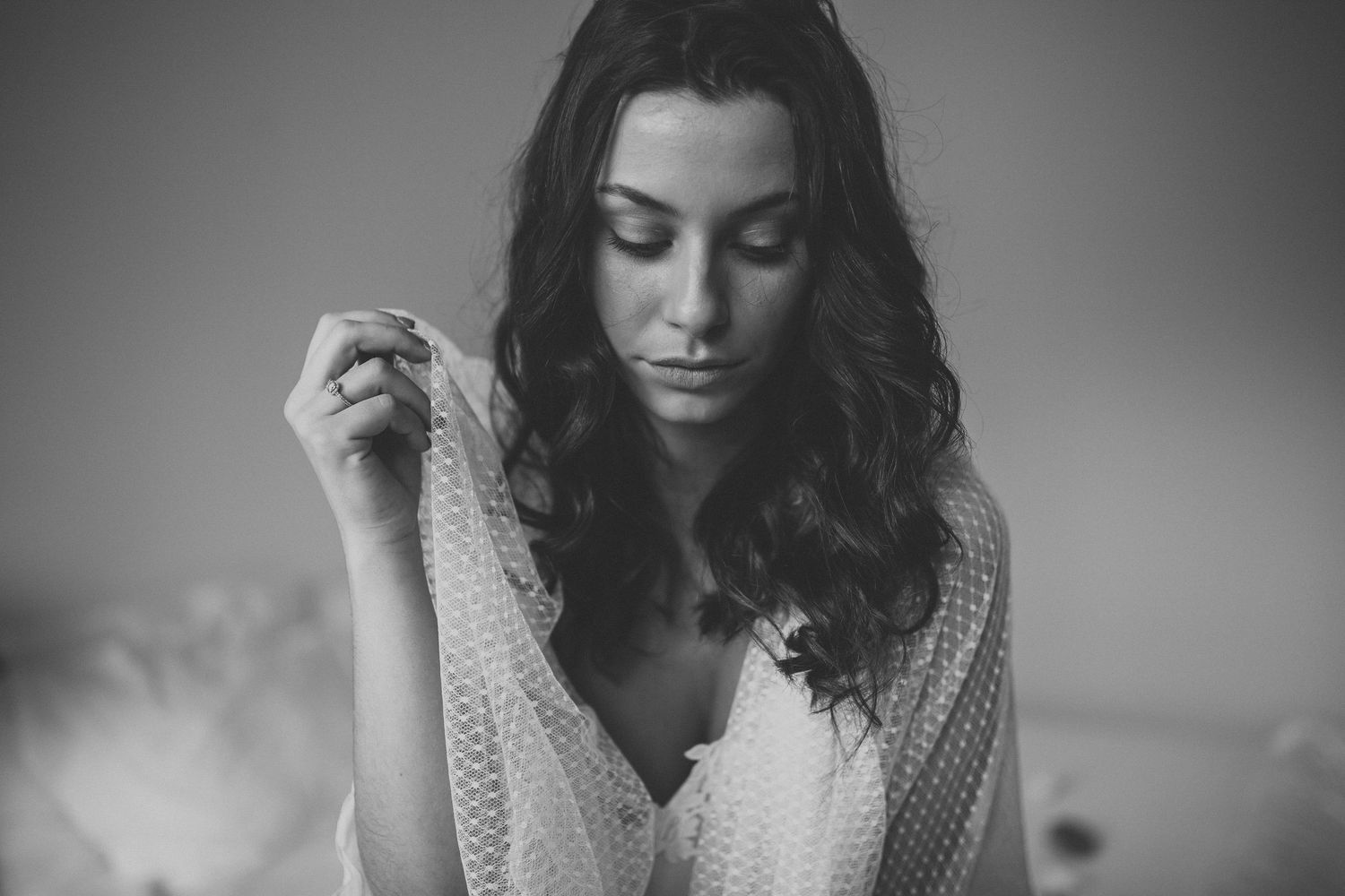 A sequence of black and white photos showing someone with curly hair wearing a knit sweater in various contemplative poses.
