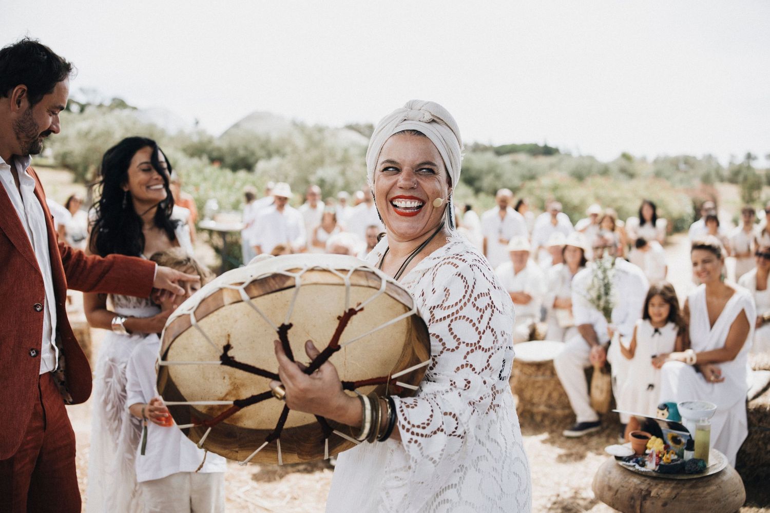 Wedding celebration with guests mingling at a sunny outdoor venue.