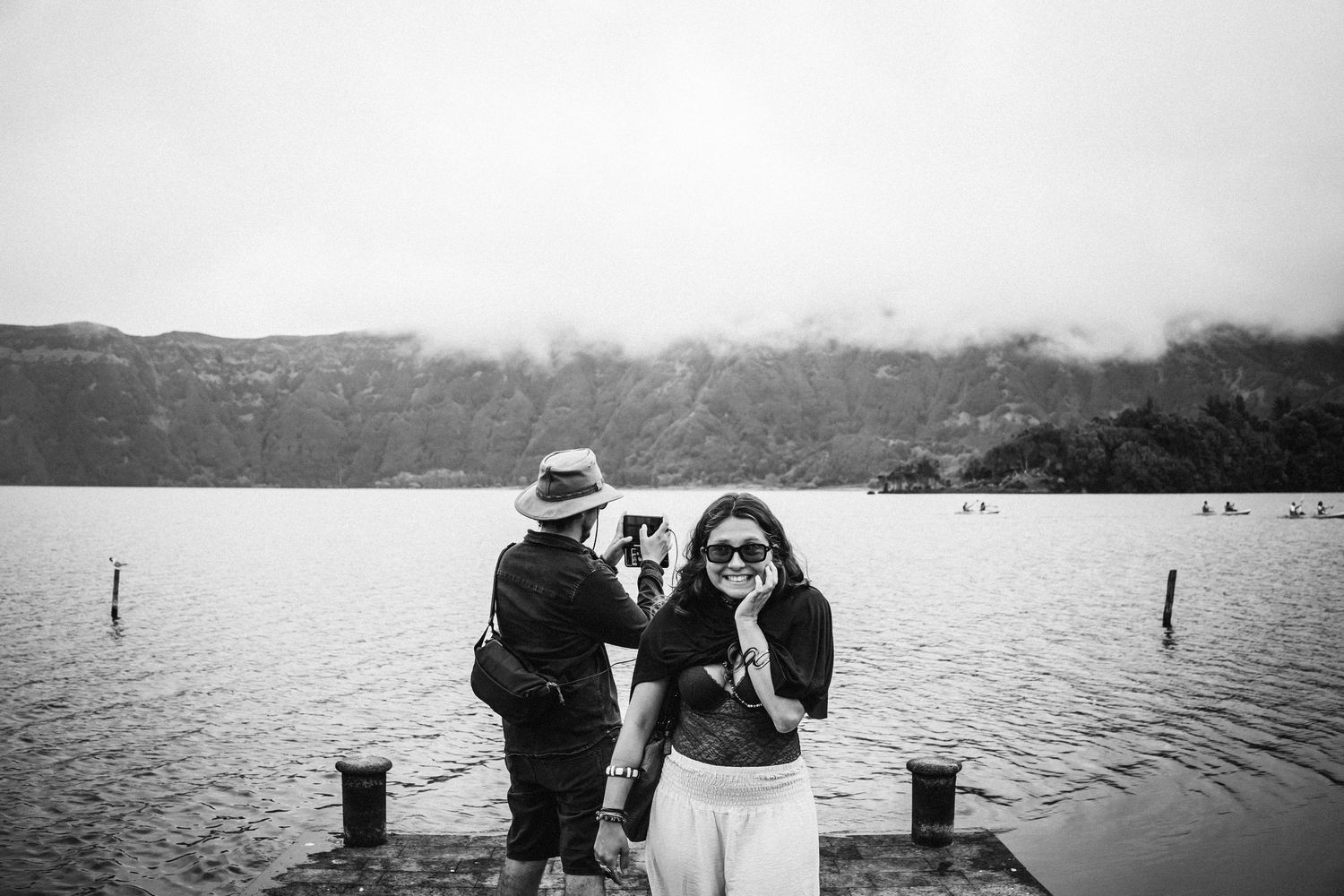 A series of black and white photographs showing boats and waterfront scenes in misty weather conditions.