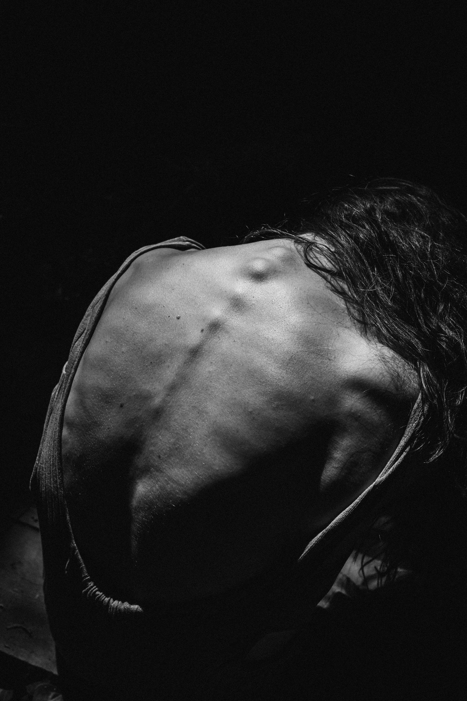 Artistic black and white profile silhouette against dark background.