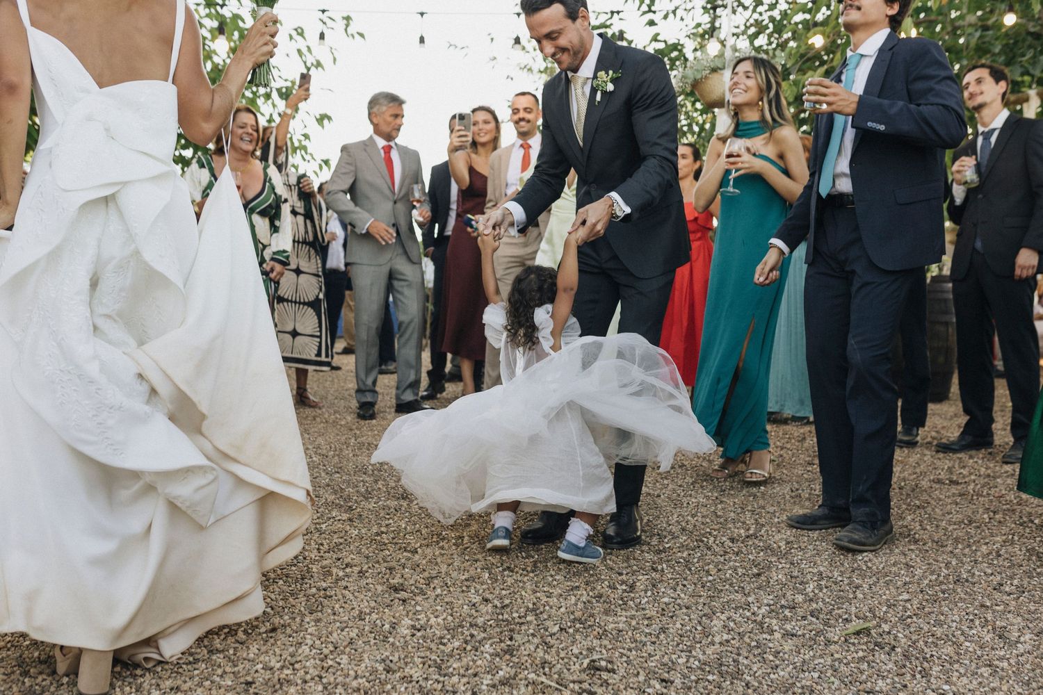 Wedding guests celebrating and dancing at an outdoor reception venue.