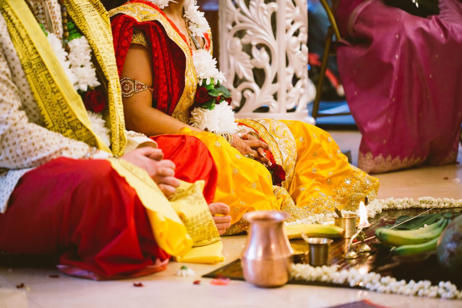 Traditional Indian wedding ceremony showing hands holding ritual items during sacred marriage customs and rituals.