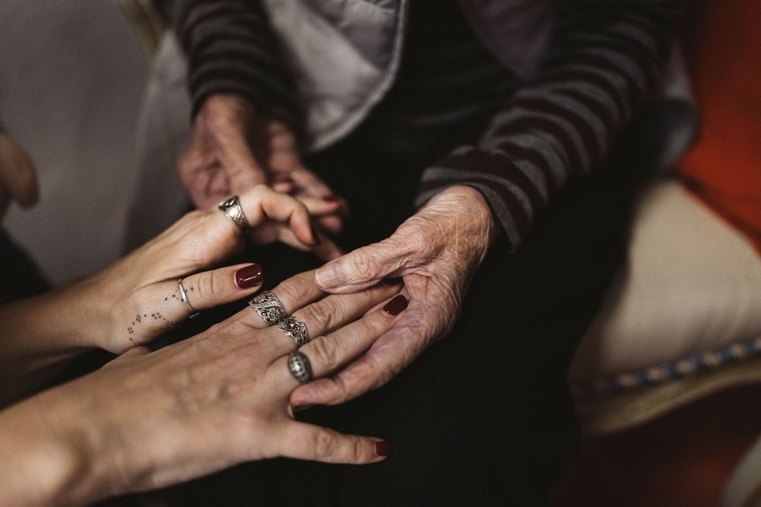 Close-up shot of hands adorned with multiple silver rings during a jewelry styling session.