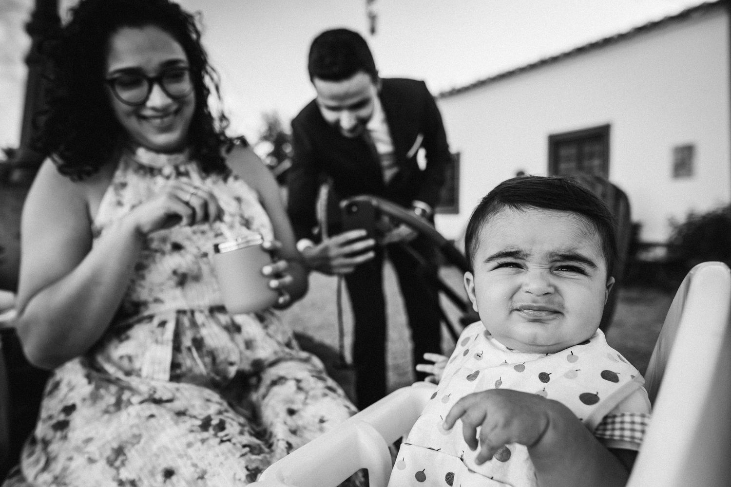 Black and white candid shots of wedding guests enjoying the reception festivities.