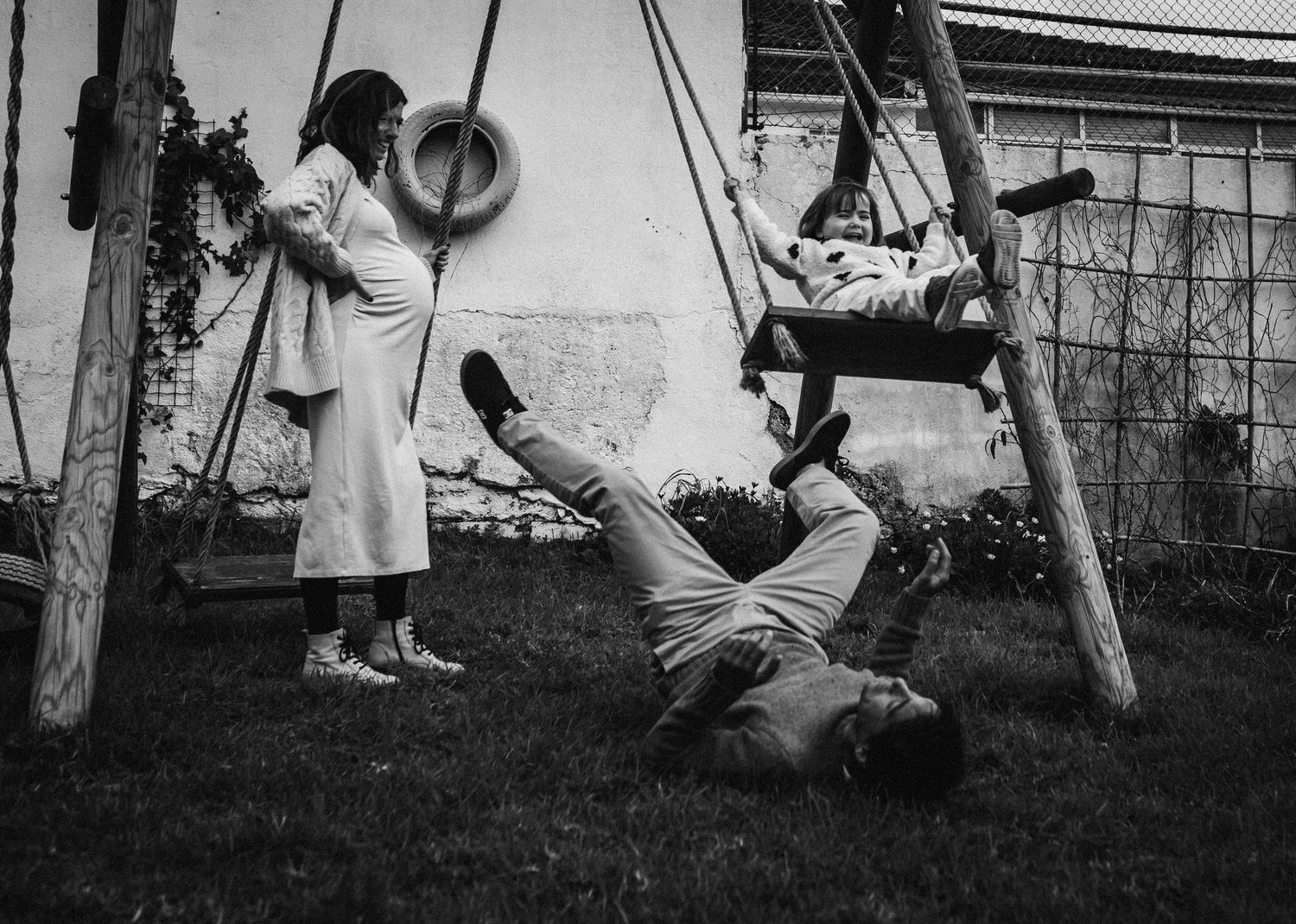 A black and white photo series showing children playing on backyard swings and playground equipment.
