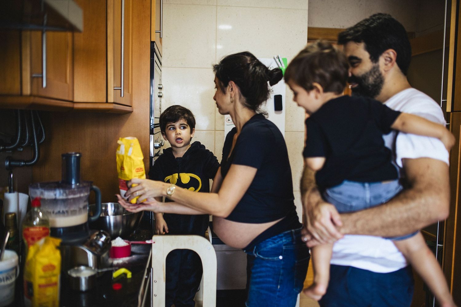 Group of people cooking together in a kitchen during what appears to be a culinary class or workshop.
