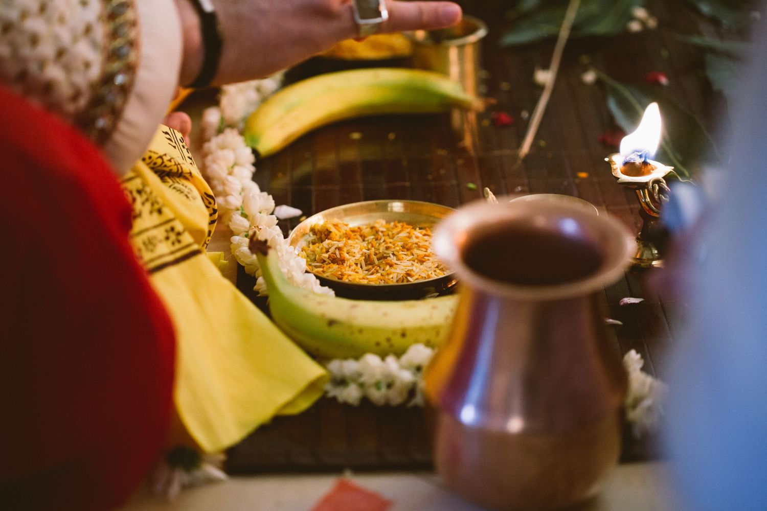 A rustic tea setting with various fruits, honey, and a brown ceramic teapot arranged on a wooden surface.