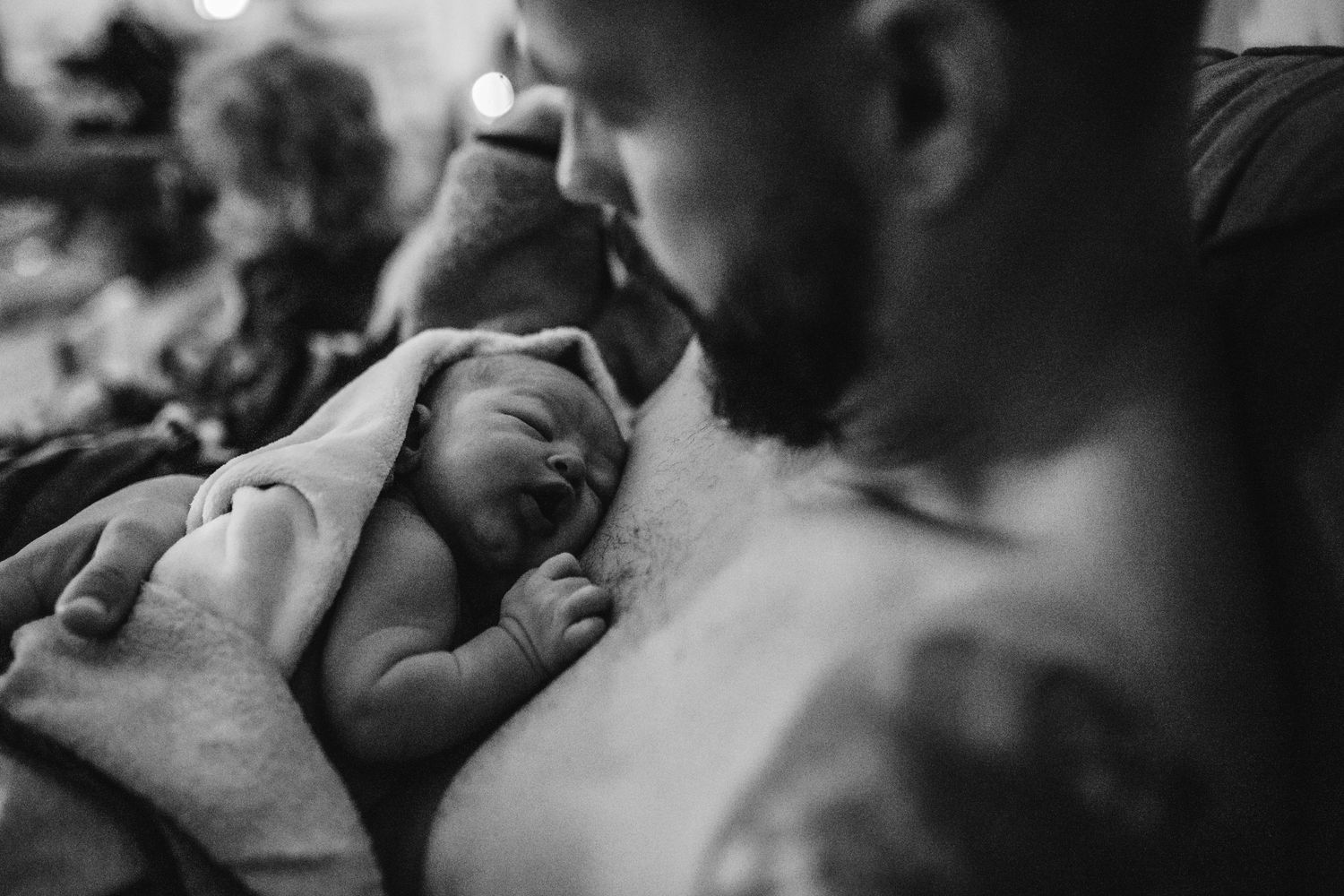 Intimate black and white photograph capturing raw emotions during labor.
