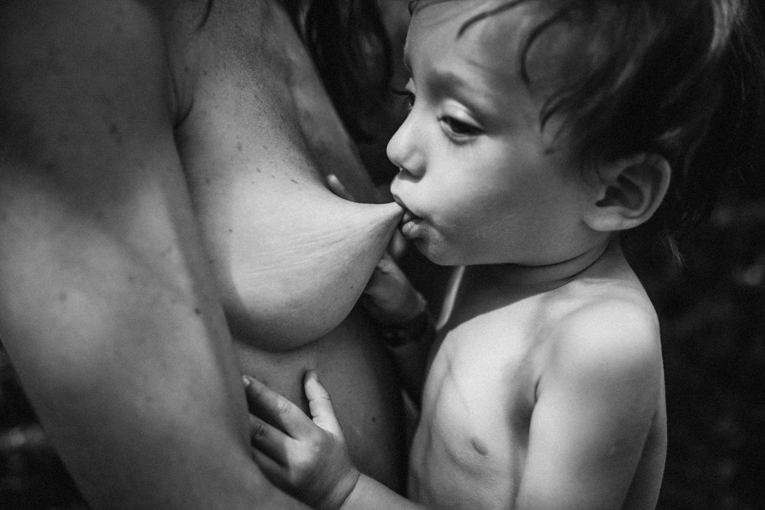 Emotional black and white photograph depicting loving interaction between parent and child.