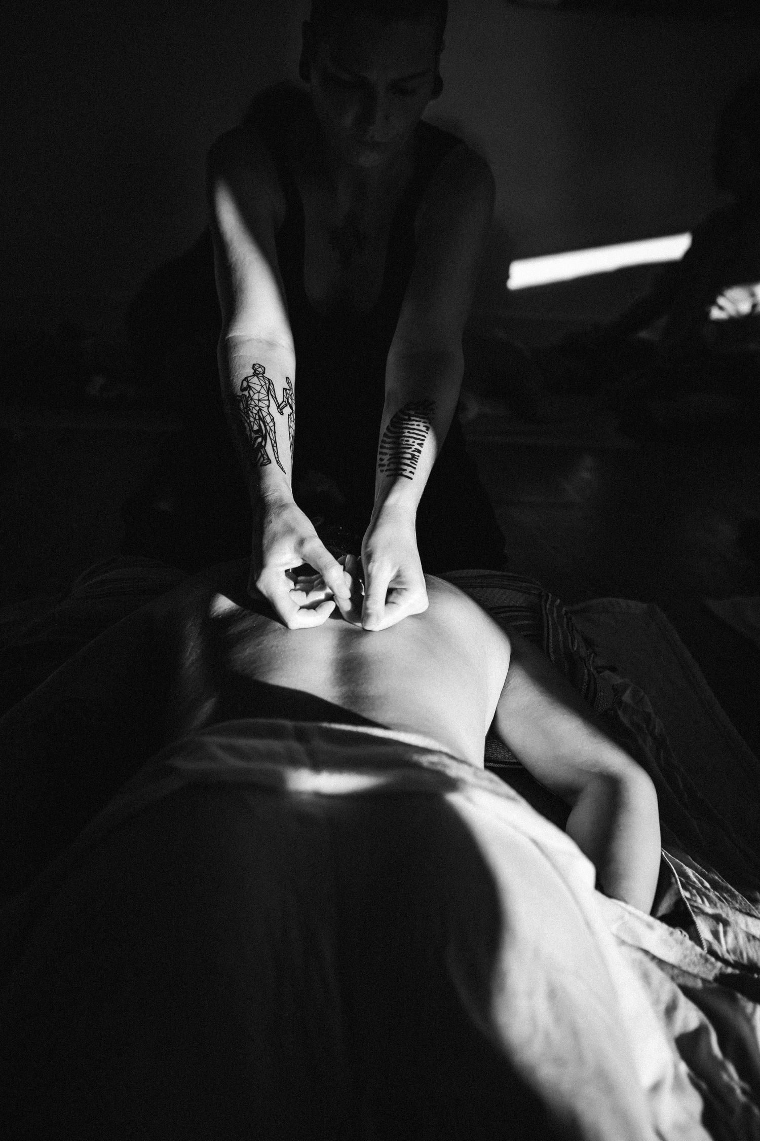 Black and white artistic photo series showing intimate close-up details of a person's neck and shoulders in low light.