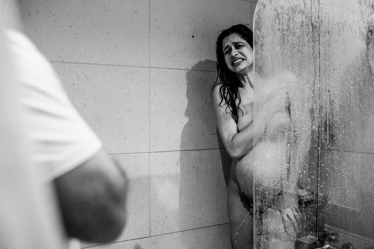 Artistic black and white composition showing emotional expressions against a textured wall.