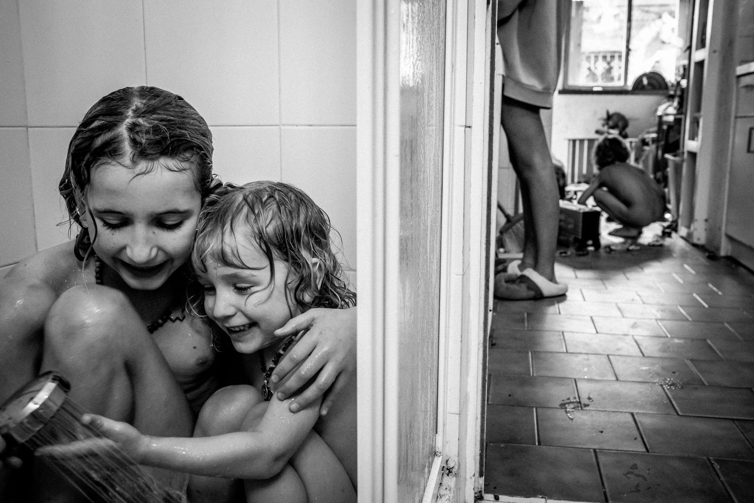 Children playing and interacting in a home hallway setting.