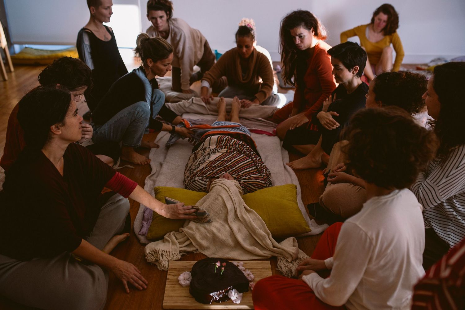 Group of people sitting together at a gathering in an indoor space.