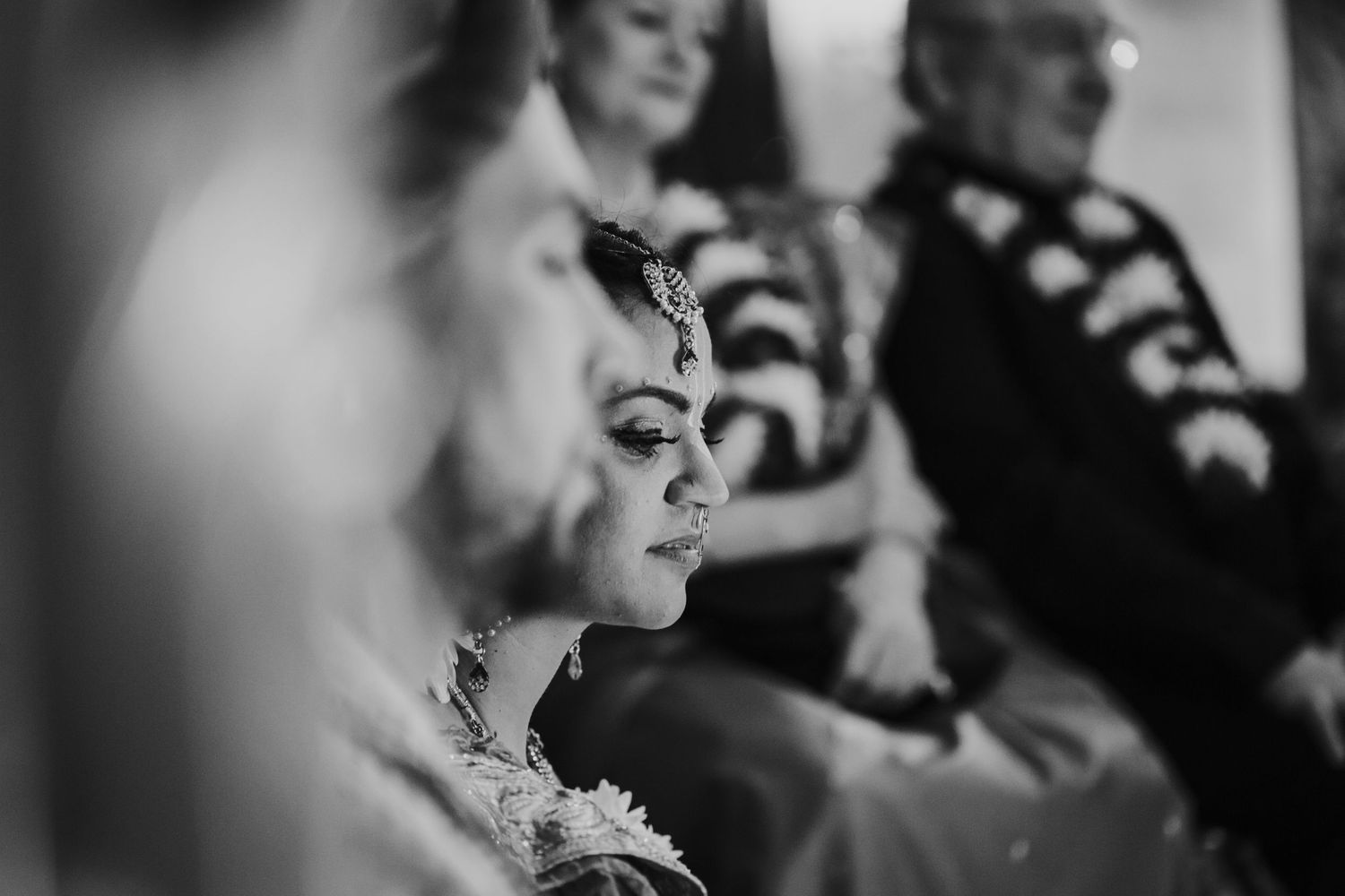 A black and white montage of candid expressions and emotional moments during a celebration or gathering.