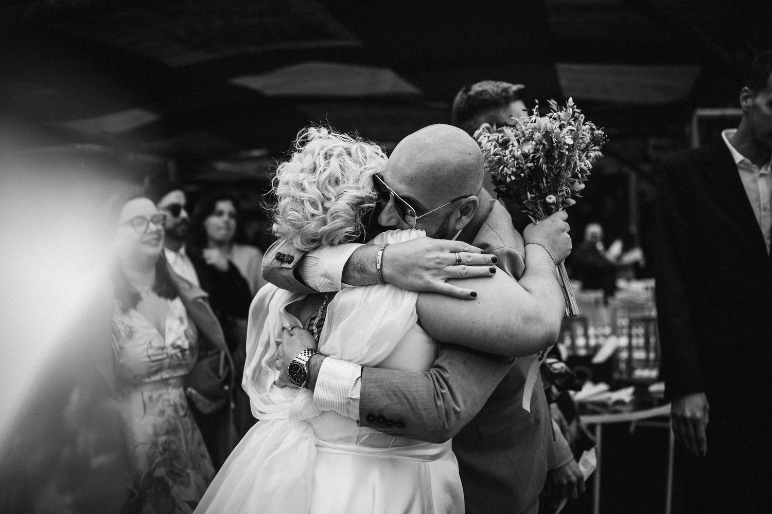 Black and white image captures an intimate dancing moment at a wedding reception.