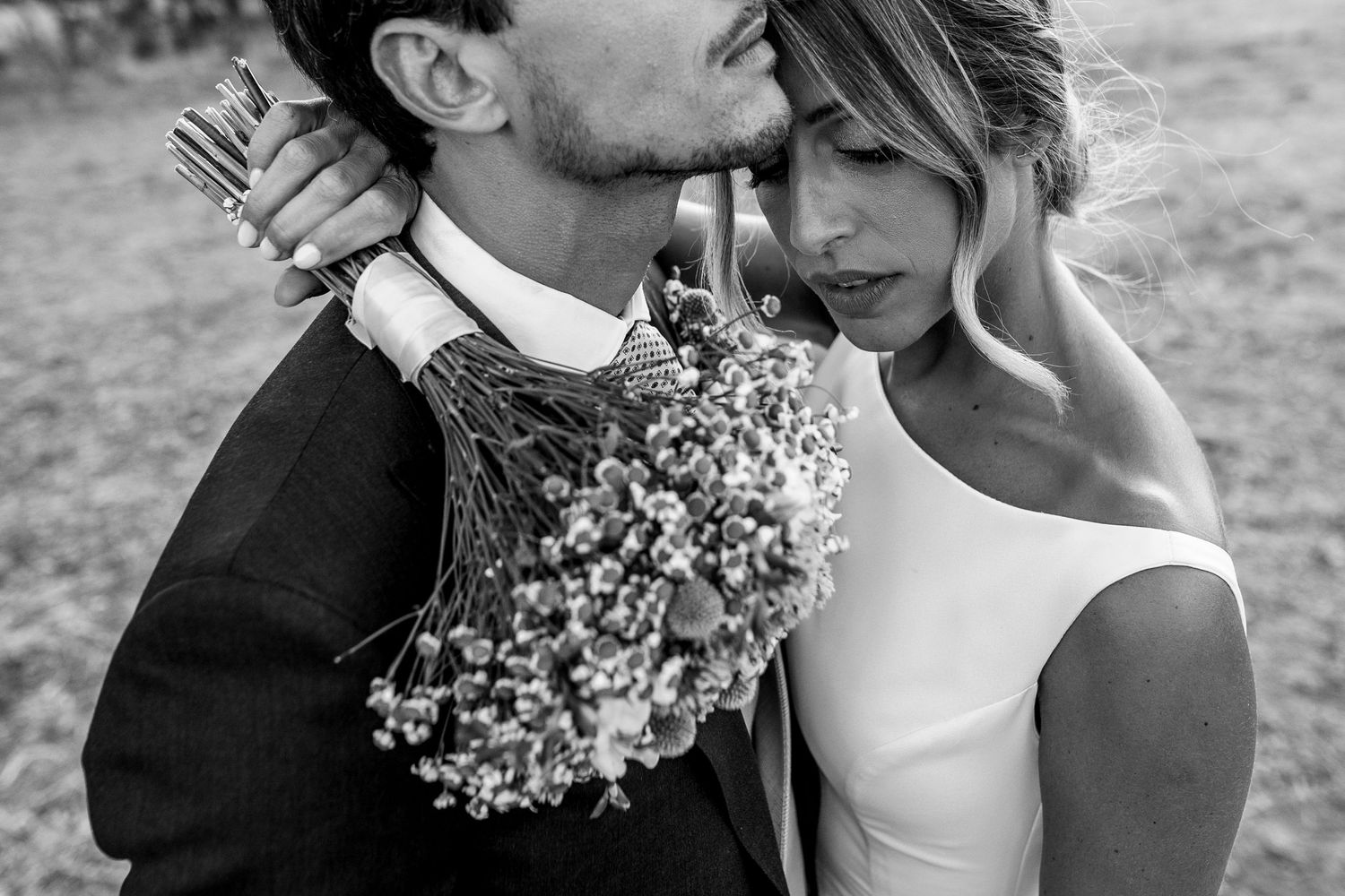 A romantic black and white wedding photo montage showing tender moments between a couple with floral bouquets.