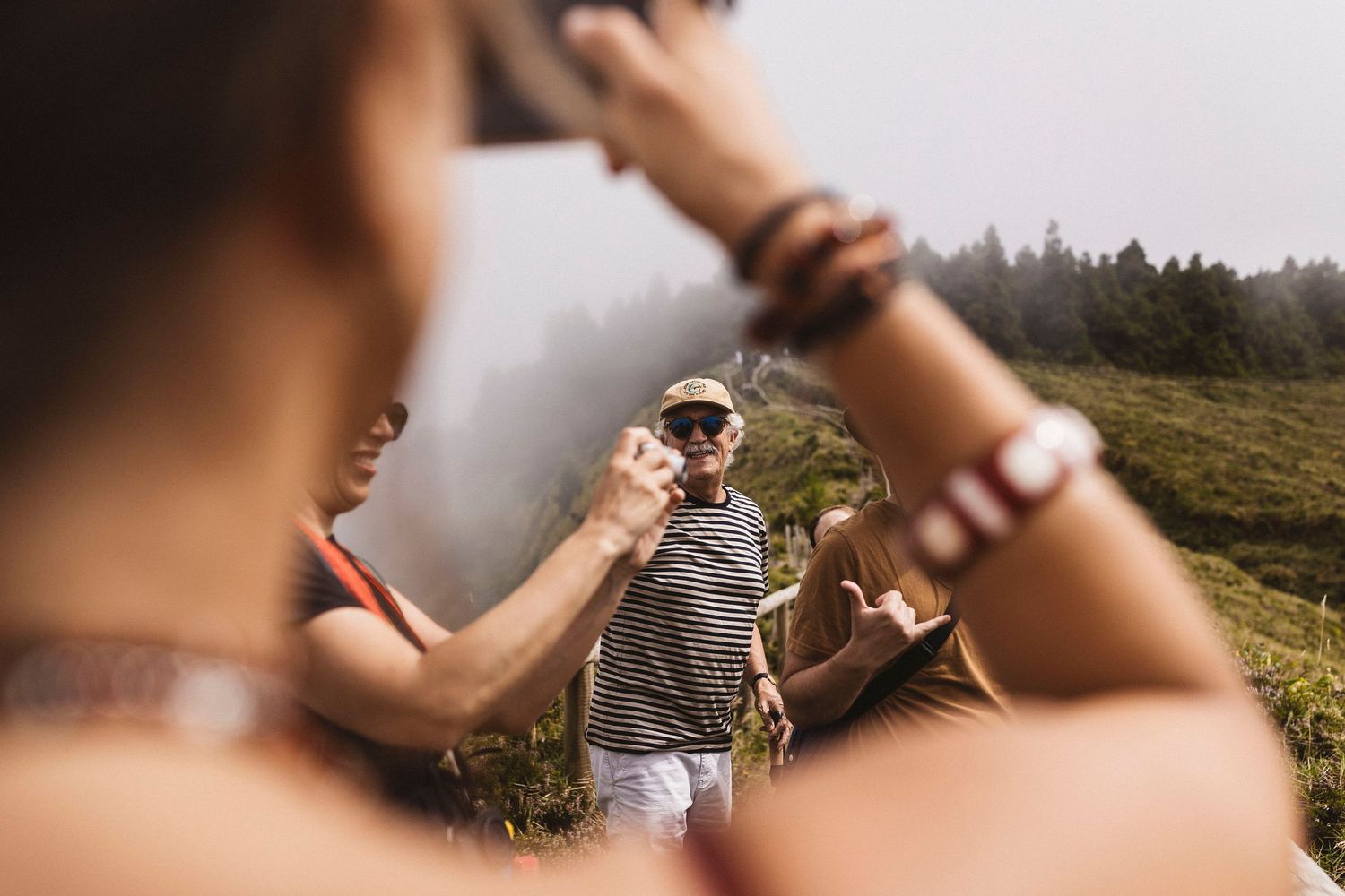 Couple in love sharing intimate moments in a scenic outdoor mountain setting at sunset.