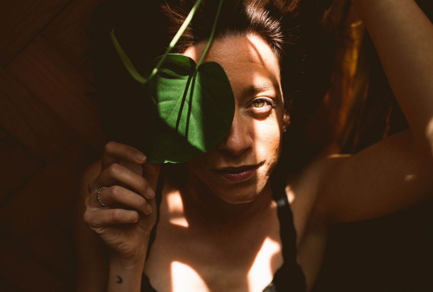 Artistic portrait series with dramatic lighting and shadows against dark background.
