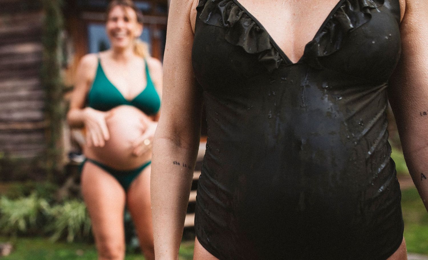 People in swimwear standing together outdoors during a summer gathering.