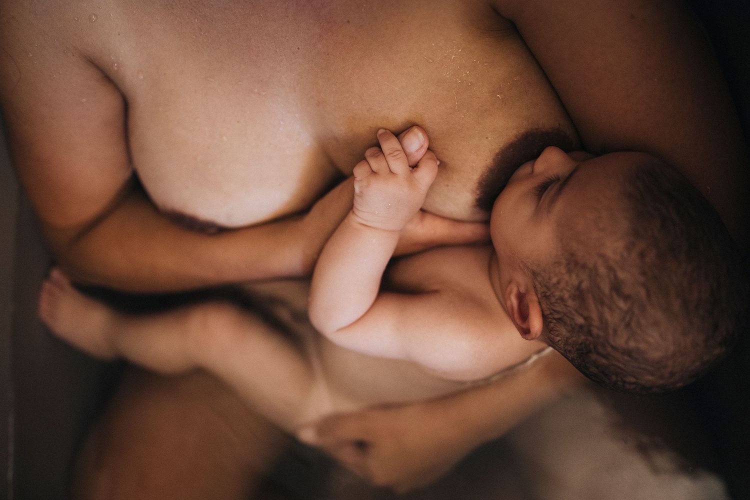 Close-up black and white portrait of nurturing breastfeeding moment.