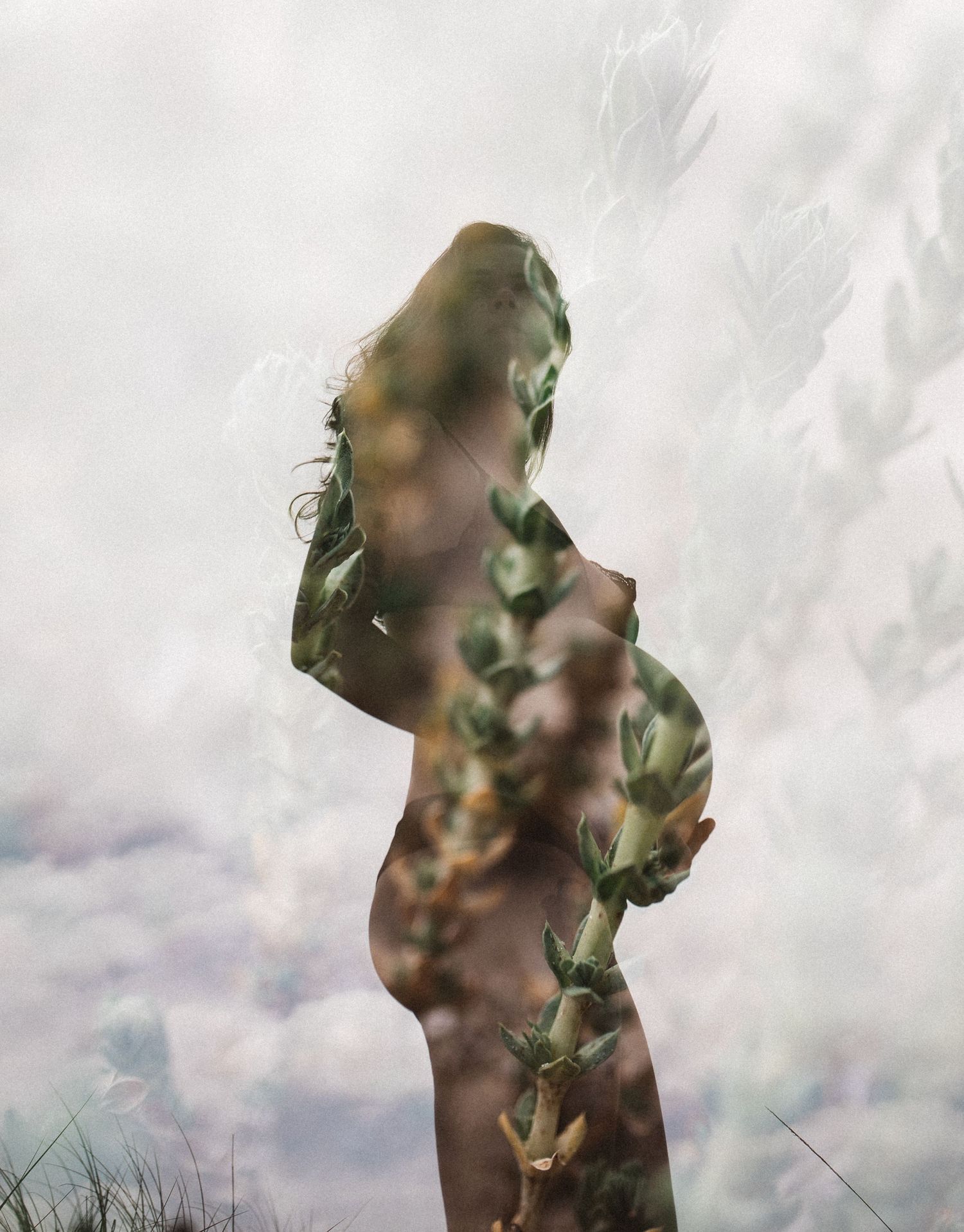 Silhouetted maternity portraits against a cloudy sky with artistic double exposure effects.