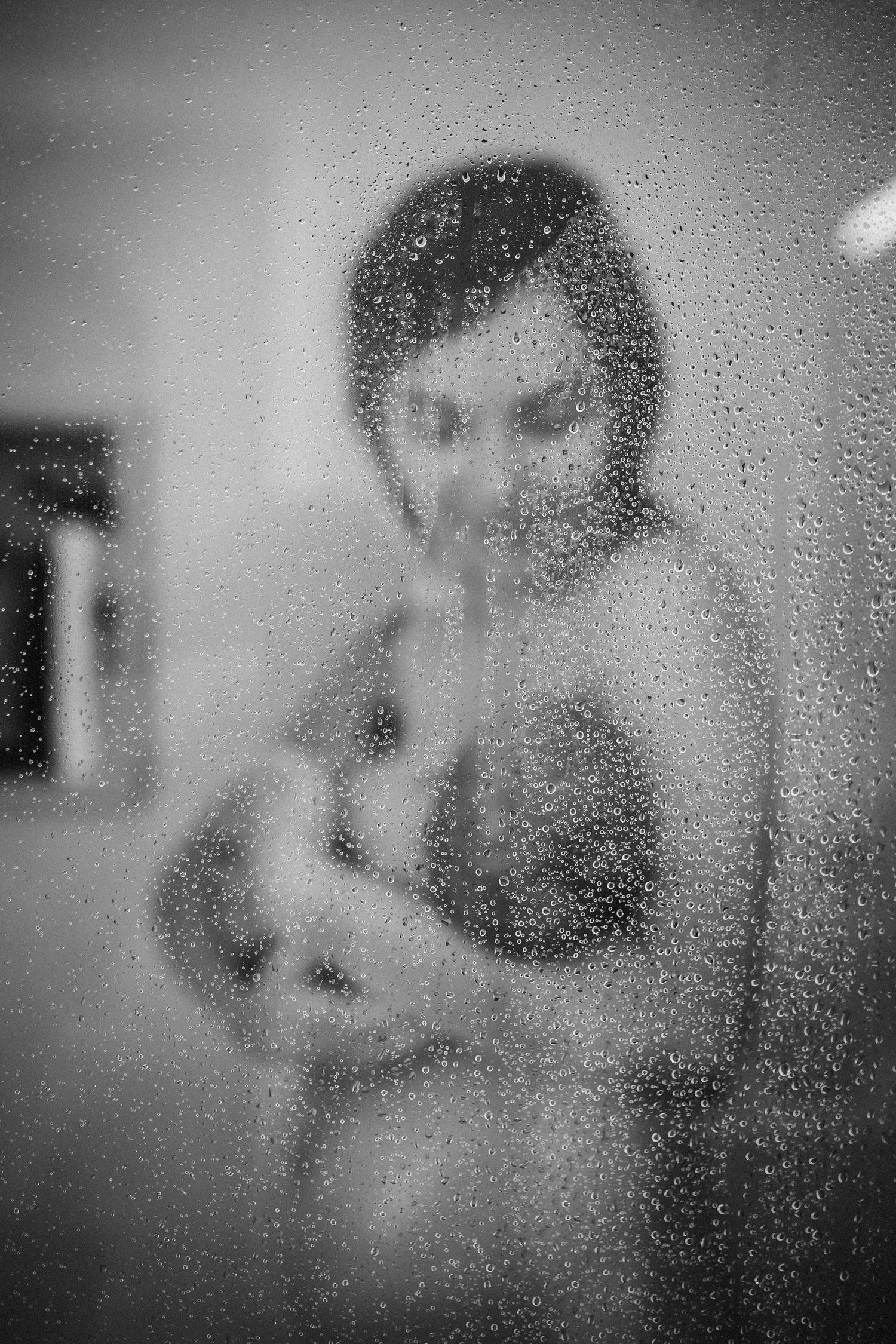 Artistic series through rain-streaked glass creating dreamy, ethereal effects.