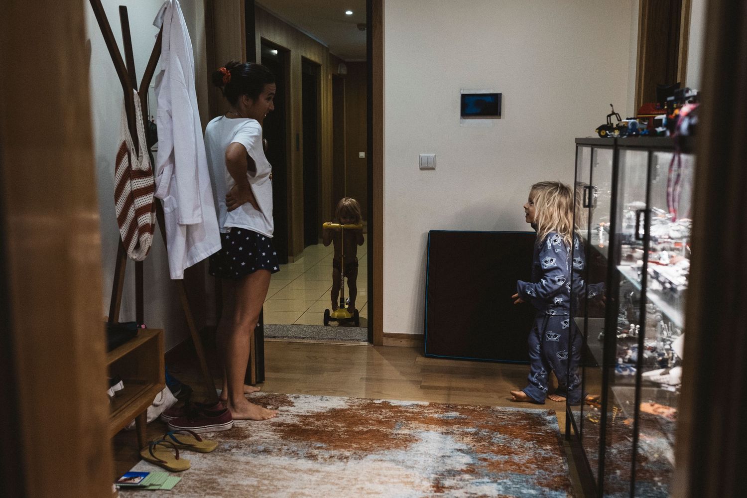 Students walk through a flooded hallway in a building with water damage.