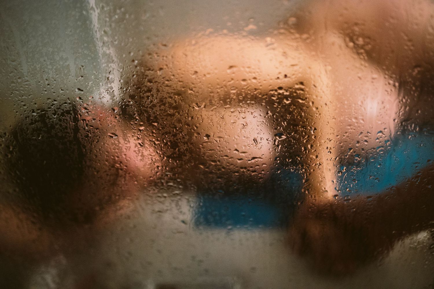 A blurred abstract background with warm brown and blue tones creates a soft bokeh effect.