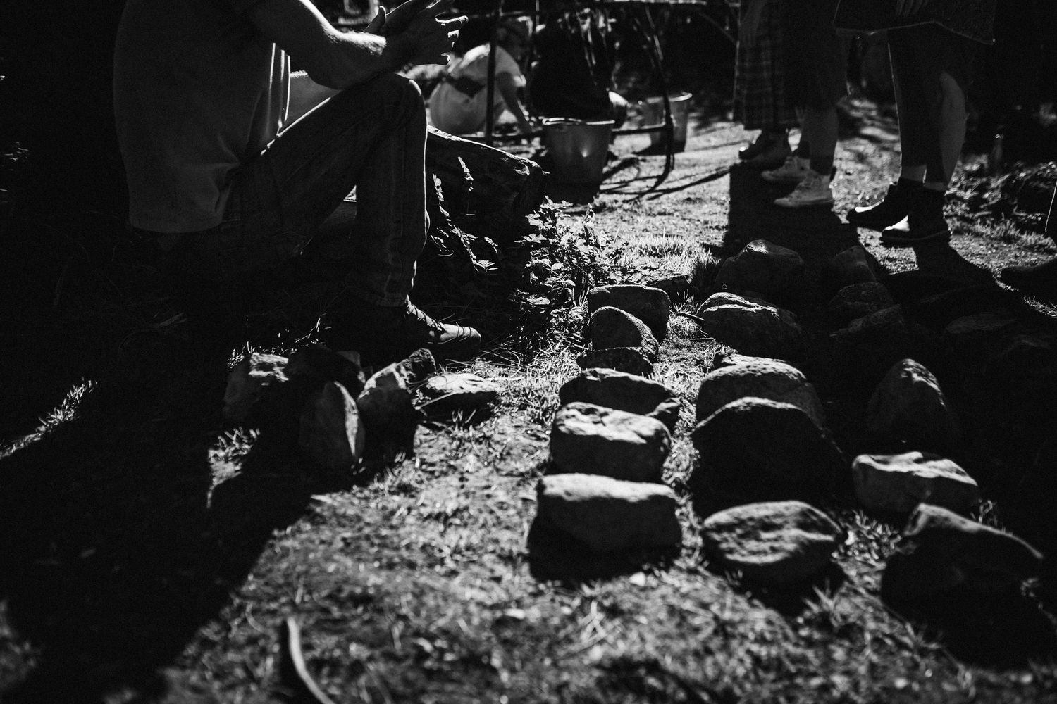 Vintage black and white photo of soldiers resting in a wooded area during wartime.