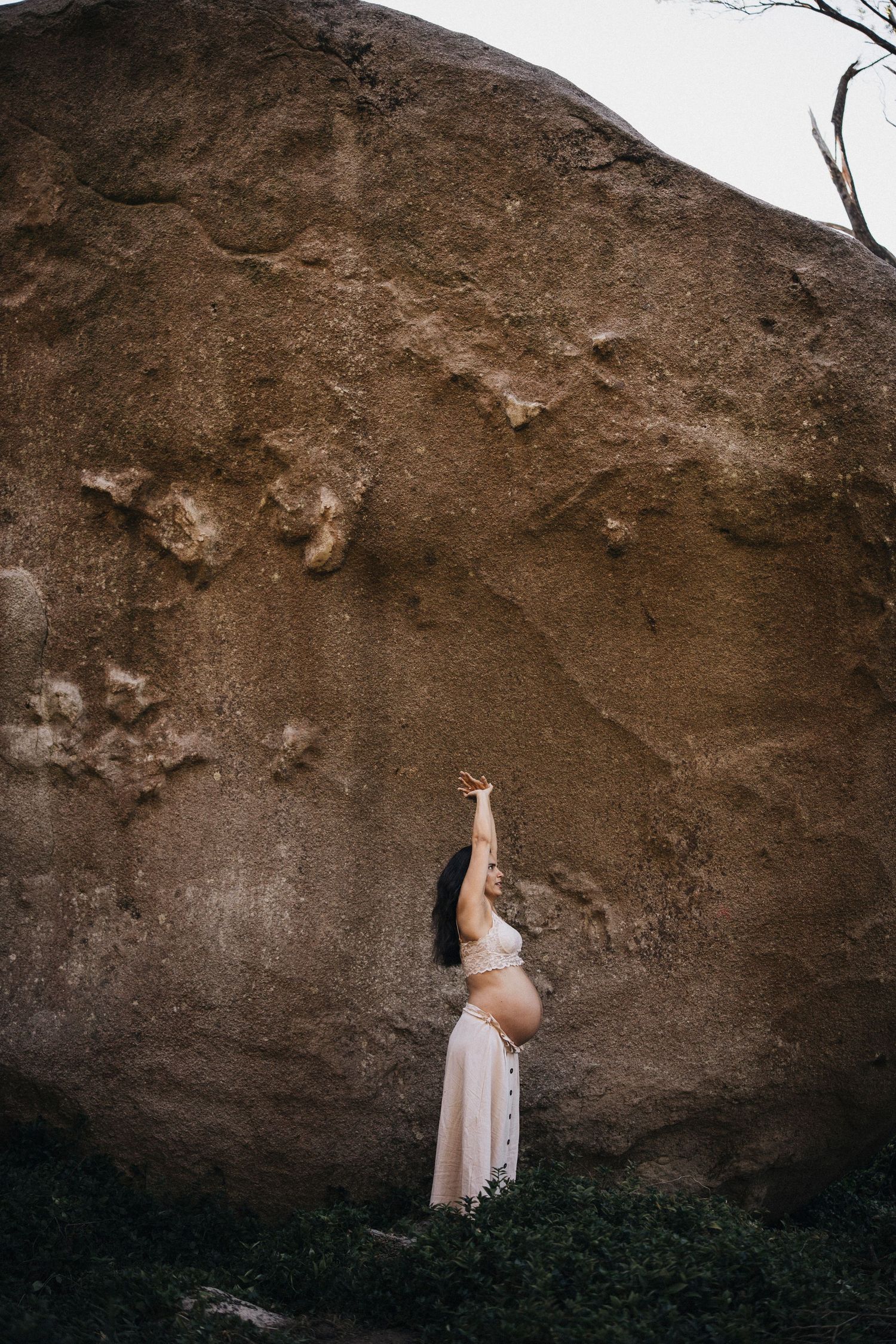 A series of artistic shots against a textured rock wall backdrop in natural lighting.
