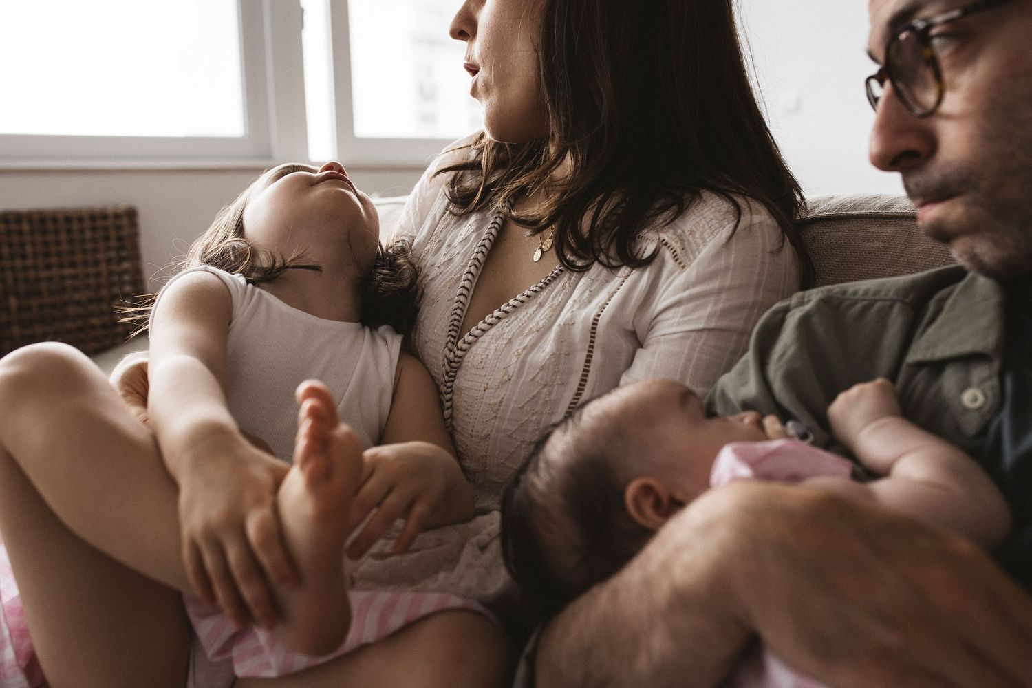 Black and white intimate portrait showing tender moments of newborn care and bonding.
